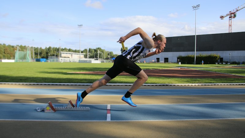 Sprinter accelerating on an outdoor track — hamstring strain physical therapy guide at Forward Physio Tampa