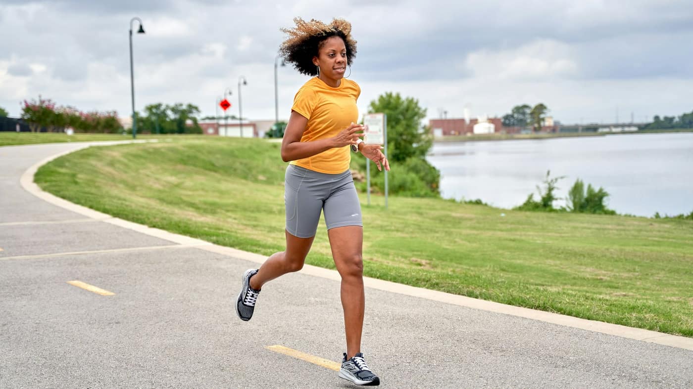 Runner at an easy pace on a flat waterfront path — the kind of route Tampa runners use to return to running with a meniscus tear.